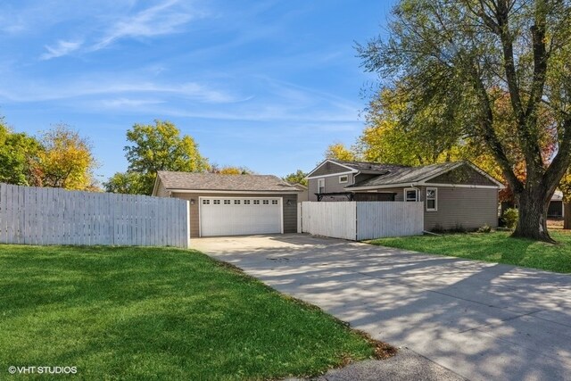 ranch-style house featuring a front yard and a garage