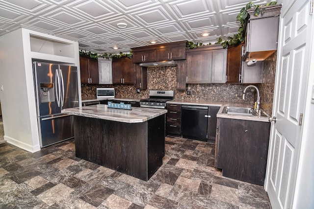 kitchen featuring a center island, sink, decorative backsplash, dark brown cabinets, and stainless steel appliances