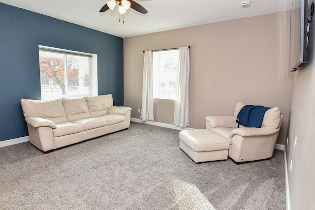 carpeted living room featuring ceiling fan and a wealth of natural light