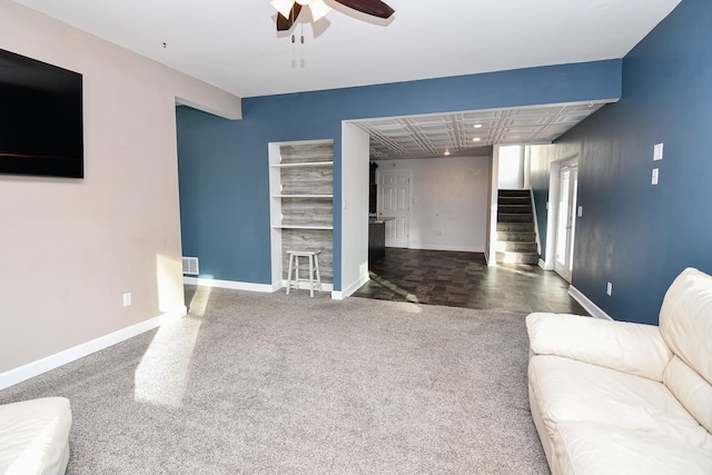 living room with dark carpet and ceiling fan