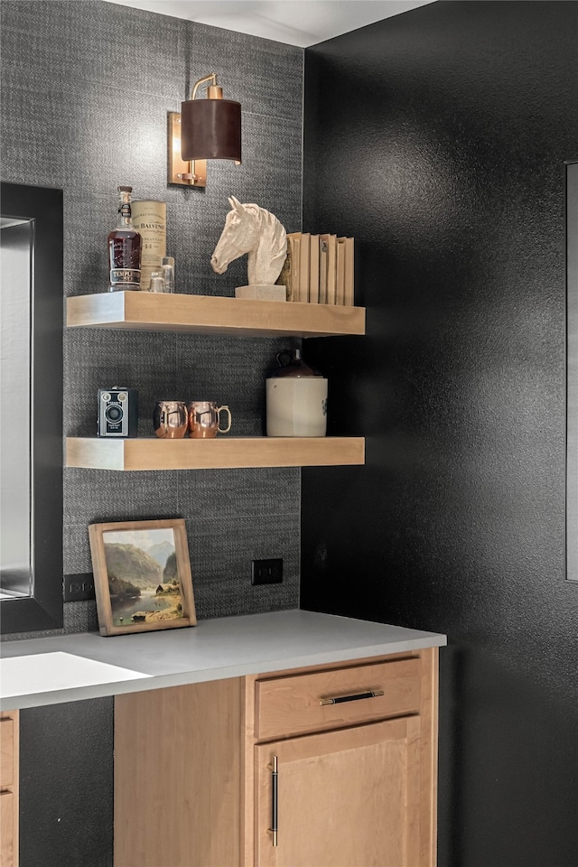 bar featuring light brown cabinetry