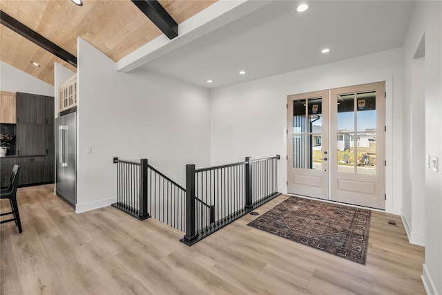 entryway featuring lofted ceiling with beams, light wood-type flooring, and wooden ceiling