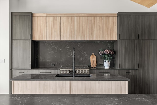 interior space with light brown cabinetry, decorative backsplash, and vaulted ceiling