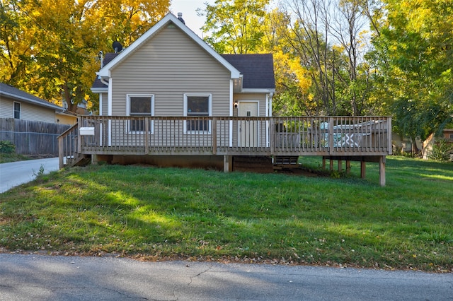 back of house featuring a wooden deck and a yard