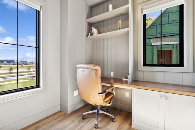 office area featuring built in desk and light wood-type flooring