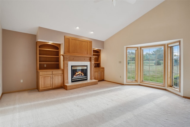 unfurnished living room featuring light carpet, high vaulted ceiling, and ceiling fan