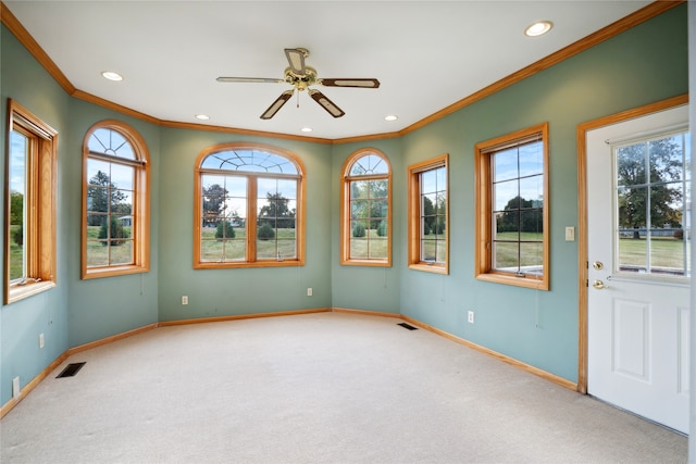 unfurnished sunroom with a wealth of natural light and ceiling fan