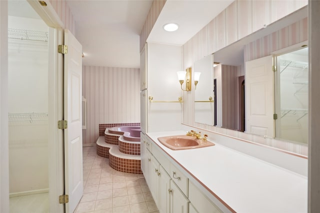 bathroom featuring vanity, a tub, and tile patterned floors