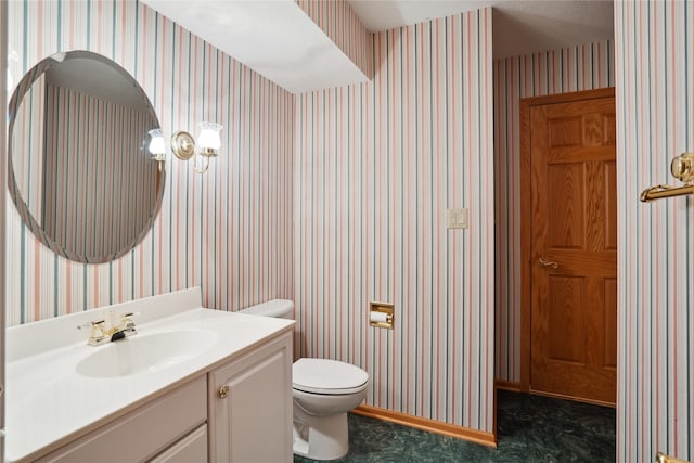 bathroom featuring vanity and toilet