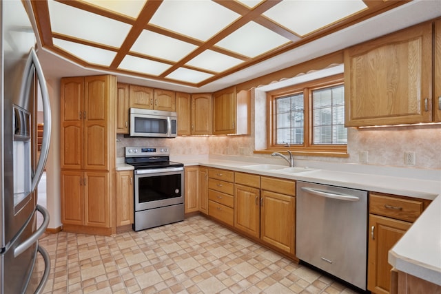 kitchen featuring backsplash, stainless steel appliances, and sink