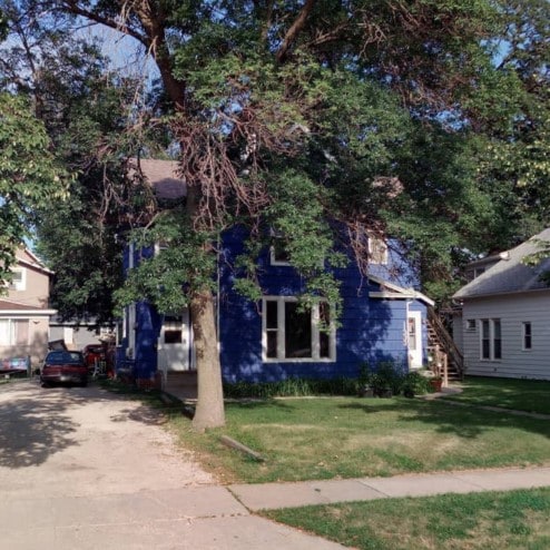 obstructed view of property with a front lawn