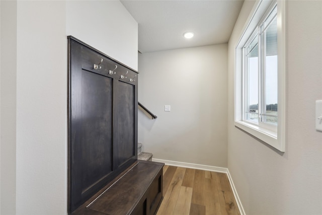 mudroom featuring wood finished floors and baseboards