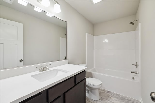 bathroom with shower / washtub combination, vanity, and toilet