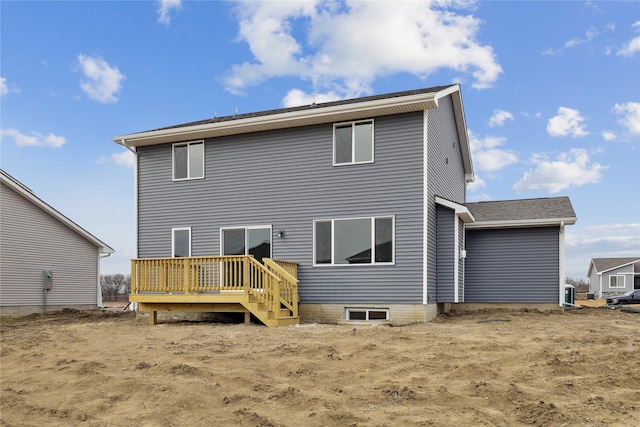 back of house featuring a wooden deck