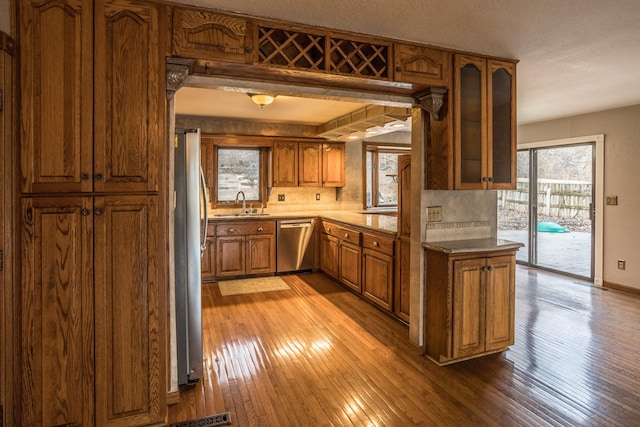 kitchen featuring stainless steel appliances, sink, and light wood-type flooring