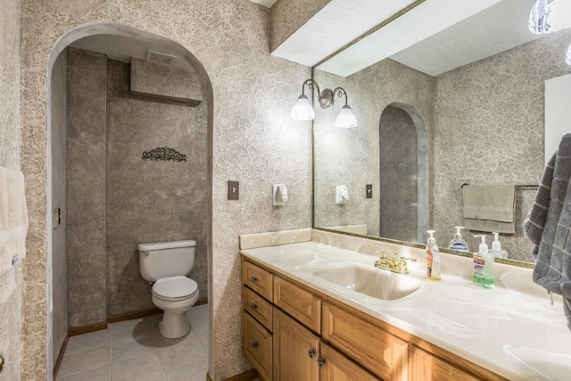 bathroom featuring vanity, toilet, and tile patterned flooring