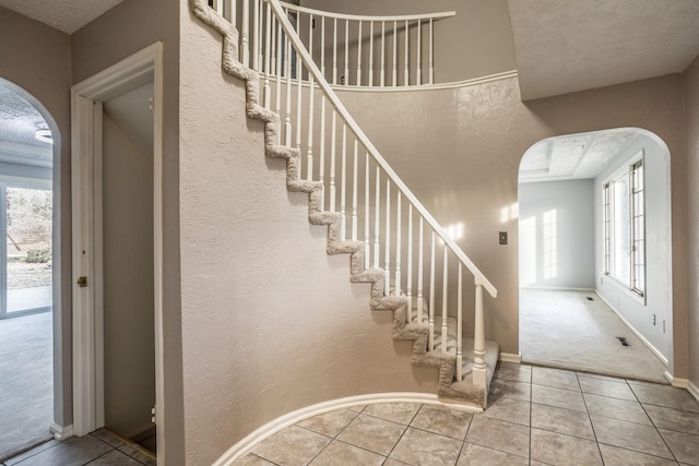 tiled foyer featuring a textured ceiling