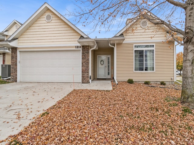 view of front facade featuring central AC unit and a garage