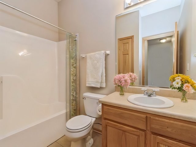 full bathroom featuring toilet, vanity, shower / bathtub combination with curtain, and tile patterned floors