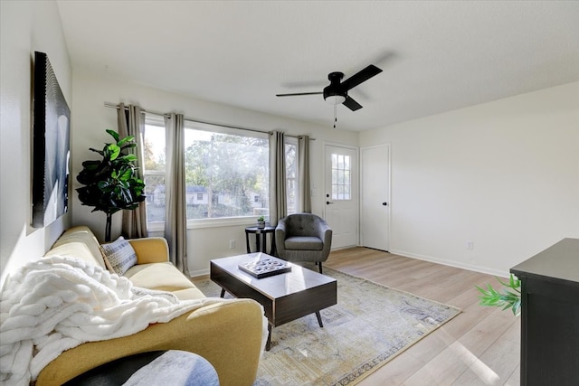 living room featuring ceiling fan and light hardwood / wood-style floors