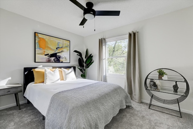 carpeted bedroom with a textured ceiling and ceiling fan