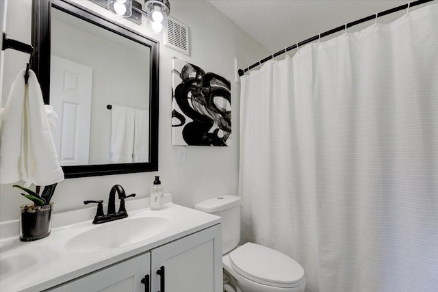 bathroom with visible vents, toilet, and vanity