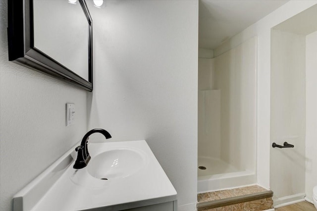 full bath with vanity and a shower stall