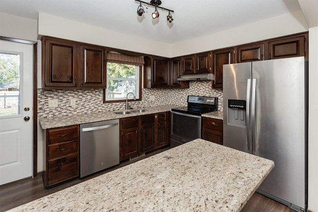 kitchen featuring a healthy amount of sunlight, appliances with stainless steel finishes, sink, and dark brown cabinets