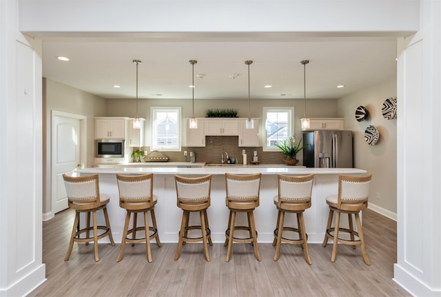 kitchen featuring white cabinets, stainless steel appliances, and a spacious island