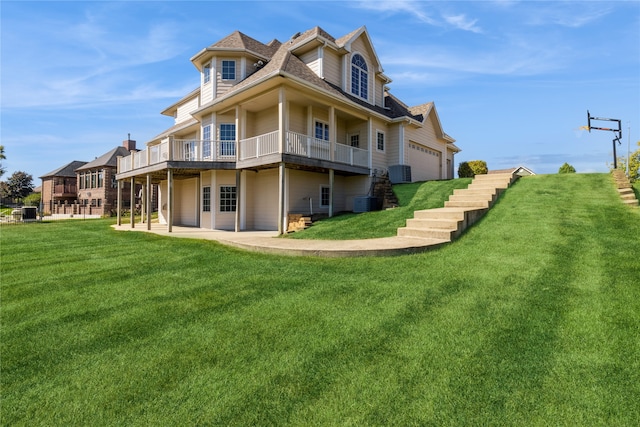 view of side of property featuring a patio, a yard, a garage, and central AC unit