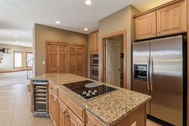 kitchen featuring appliances with stainless steel finishes, wine cooler, a center island, and light tile patterned floors