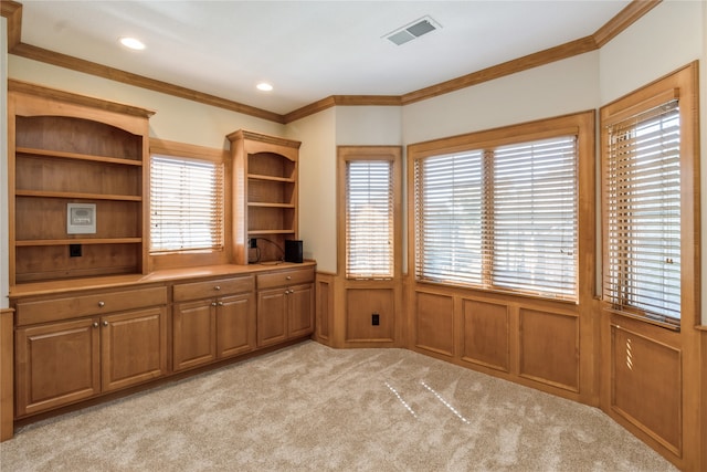 unfurnished office with ornamental molding and light colored carpet