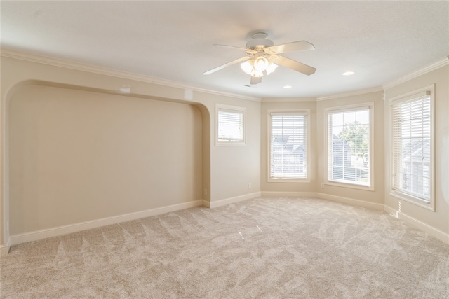 carpeted empty room featuring ceiling fan and ornamental molding