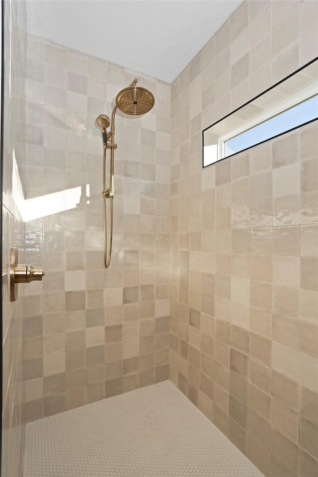 bathroom with a tile shower