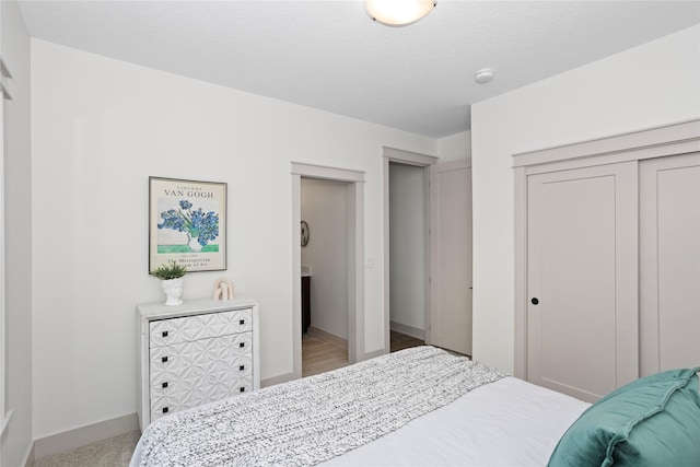 bedroom with baseboards and a closet