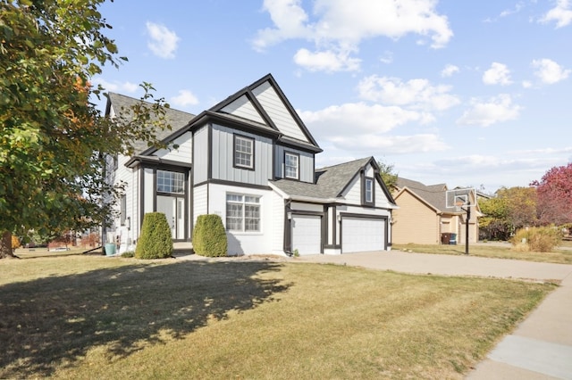 tudor home with a front yard and a garage