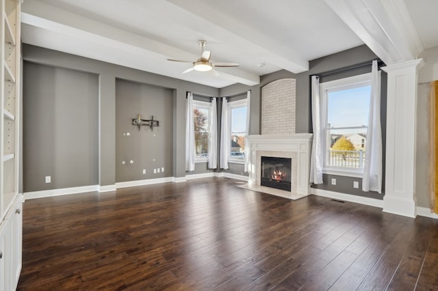 unfurnished living room with ceiling fan, beam ceiling, and dark hardwood / wood-style floors