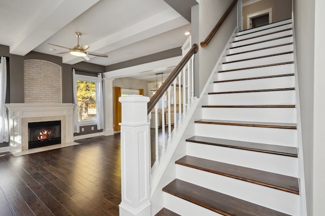 stairs featuring ornate columns, hardwood / wood-style flooring, and ceiling fan