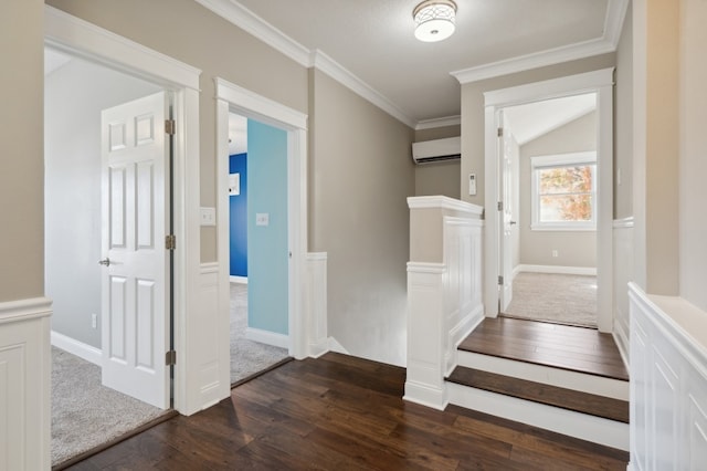 hallway with an AC wall unit, dark wood-type flooring, vaulted ceiling, and crown molding