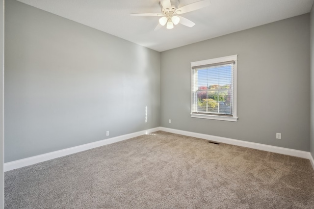 unfurnished room with ceiling fan and carpet floors