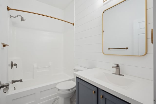 full bathroom with vanity, toilet, wood walls, and washtub / shower combination