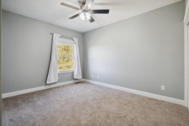 spare room with carpet floors and ceiling fan