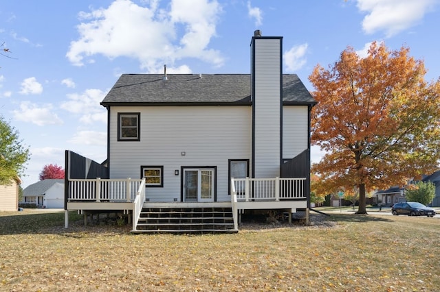 rear view of property with a yard and a deck