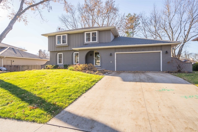 view of property featuring a front lawn and a garage