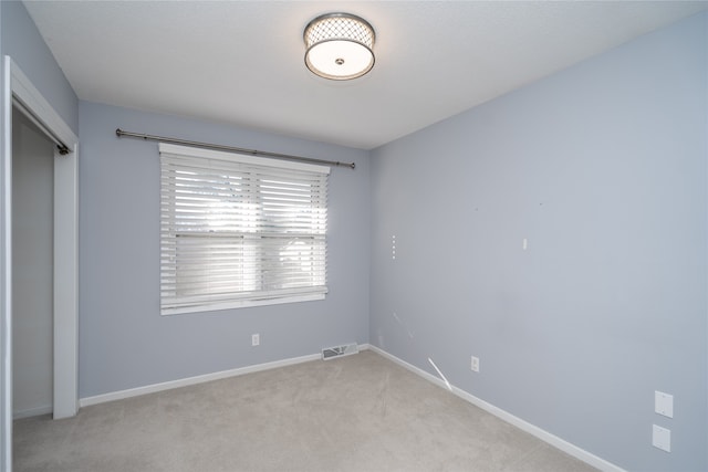 unfurnished bedroom featuring light colored carpet