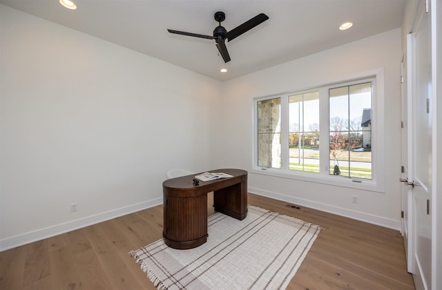 interior space featuring a ceiling fan, recessed lighting, baseboards, and wood finished floors