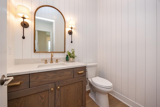 bathroom featuring toilet and vanity