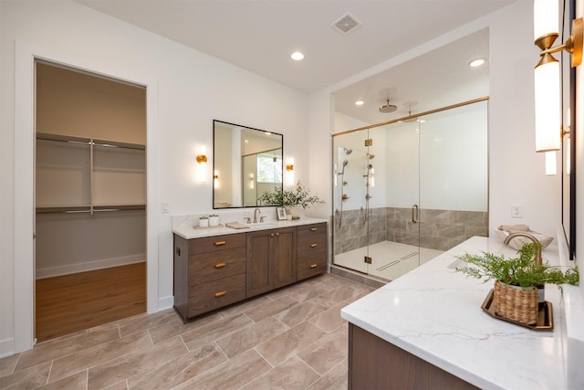 full bath featuring a stall shower, vanity, visible vents, and recessed lighting