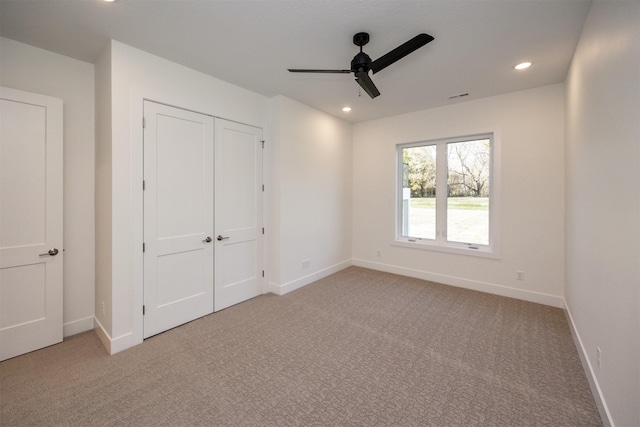 unfurnished bedroom with light carpet, baseboards, and recessed lighting