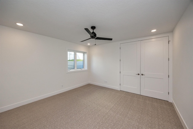 unfurnished bedroom featuring recessed lighting, light carpet, a ceiling fan, baseboards, and a closet